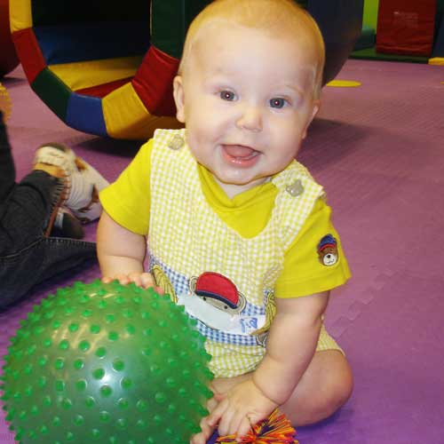This sweet, smiling baby loves Romp n' Roll's baby activities.