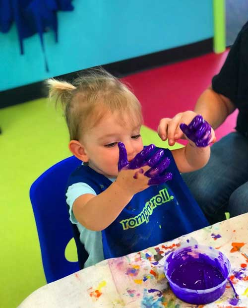 Our classes can get a little messy, like this girl finger painting at our preschool art classes in Wethersfield - but don't worry, we take care of the mess.