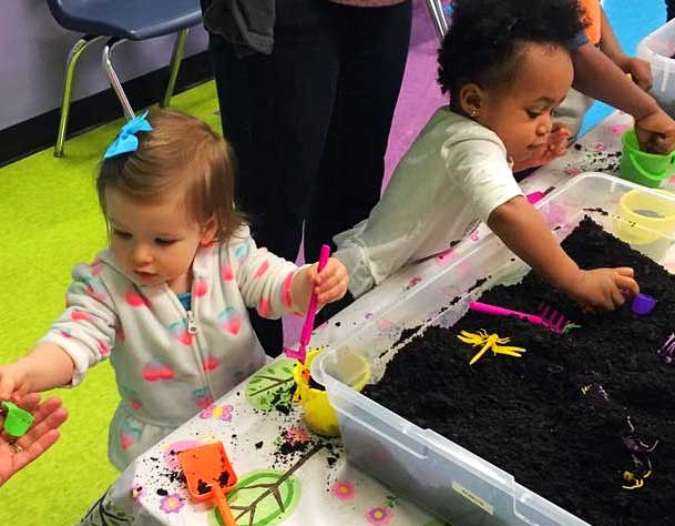 These cute tots make a mess and have fun learning motor skills at Romp n' Roll North Raleigh's toddler gym in Raleigh.