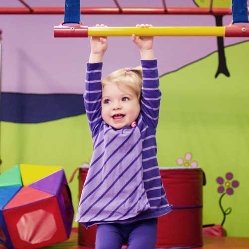 Cute, young girl enjoying children’s fitness classes with Romp n' Roll.