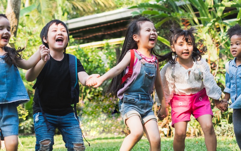 Kids playing and socializing with friends outdoors Romp n' Roll.