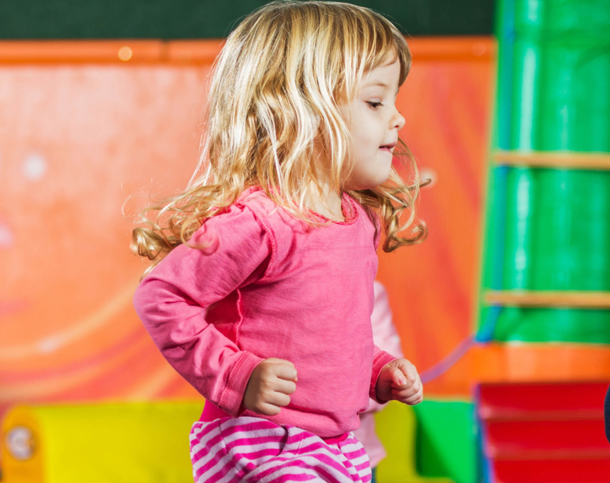 A little girl dancing at a Romp n' Roll focused activity class. 