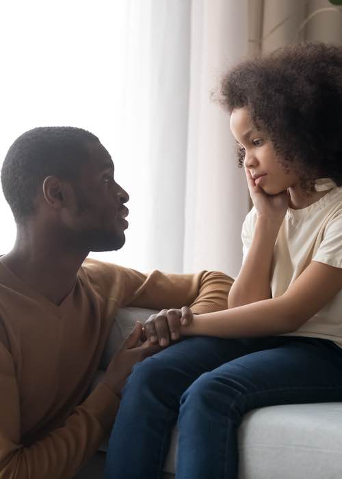 Father talking to daughter helping her learn different coping skills - contact Romp n' Roll Pittsburgh to learn effective communication skills.