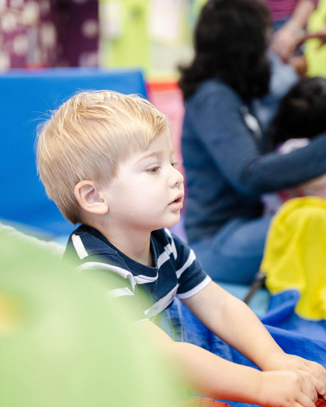 A young boy in a Romp n' Roll facility - we offer a sensory gym for autism.