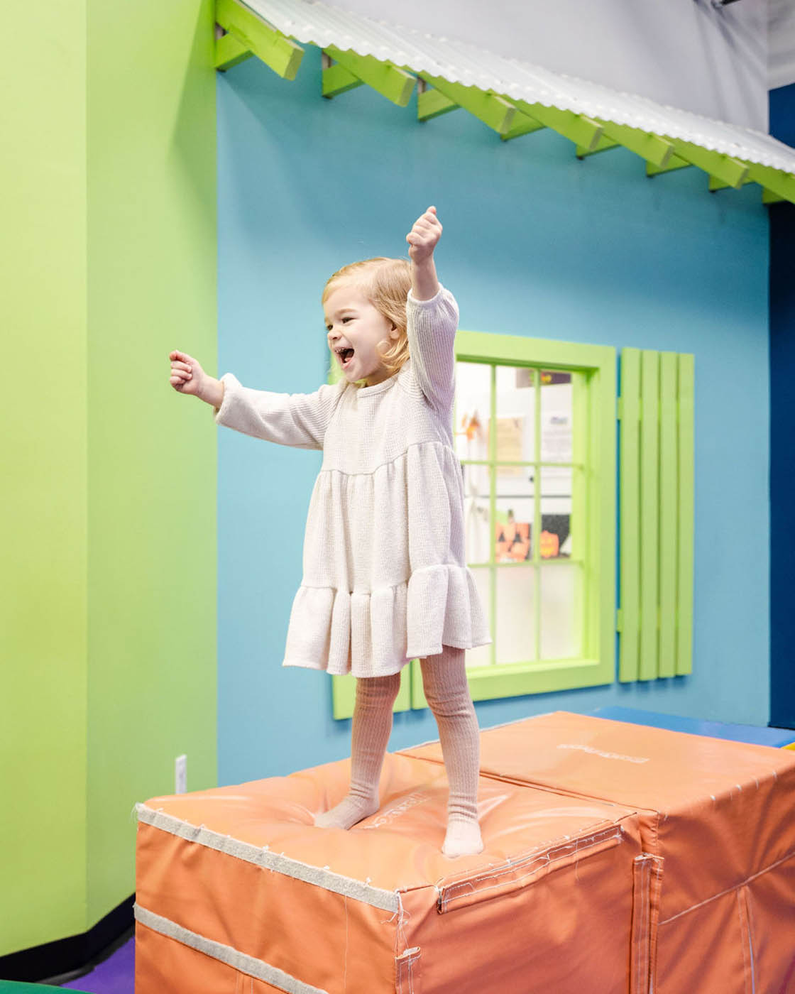 A little girl playing in one of Romp n' Roll's playgroups.