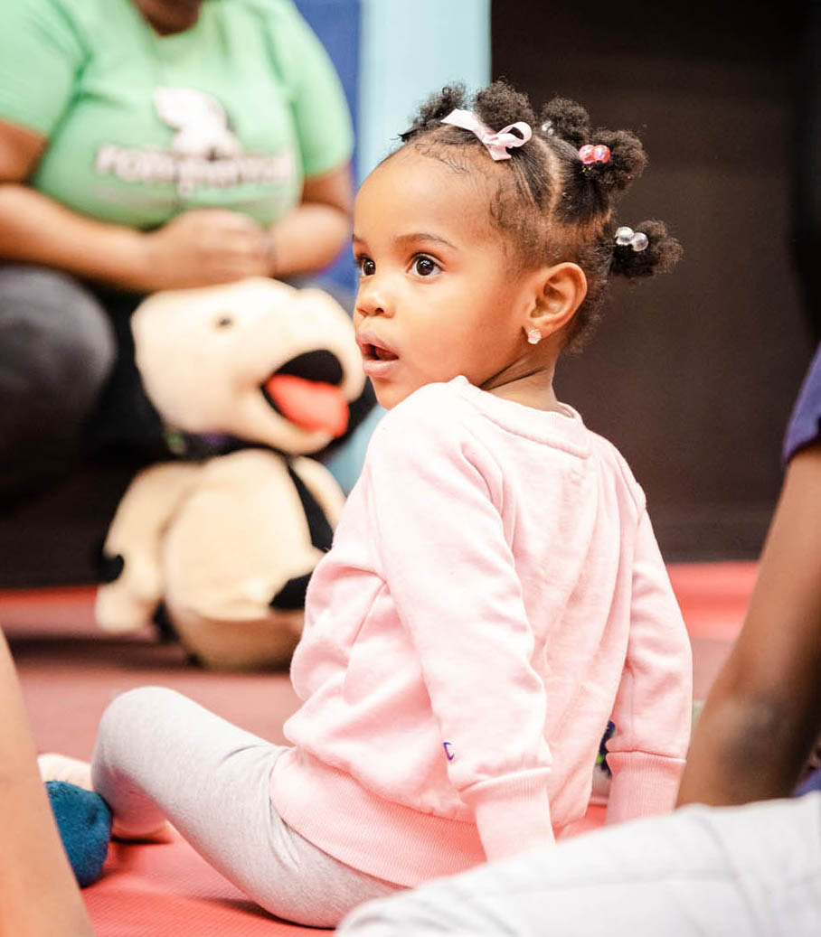 A little girl sitting in a Romp n' Roll facility.
