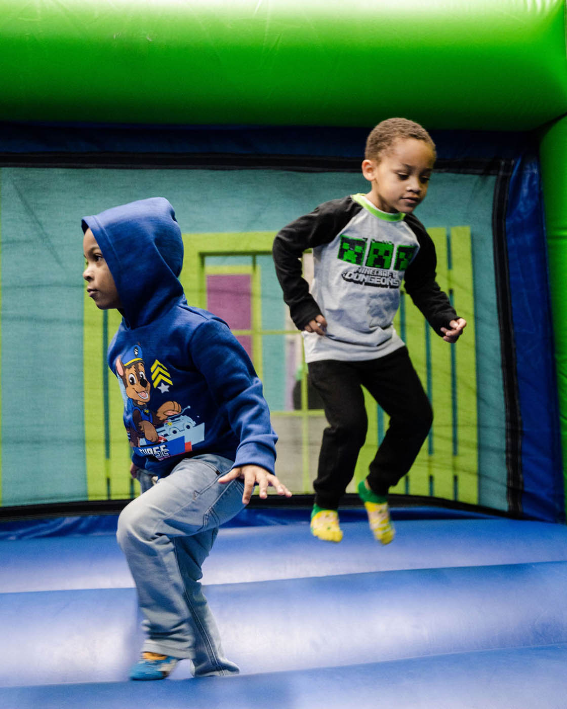 Two boys playing together at a Romp n' Roll gym.