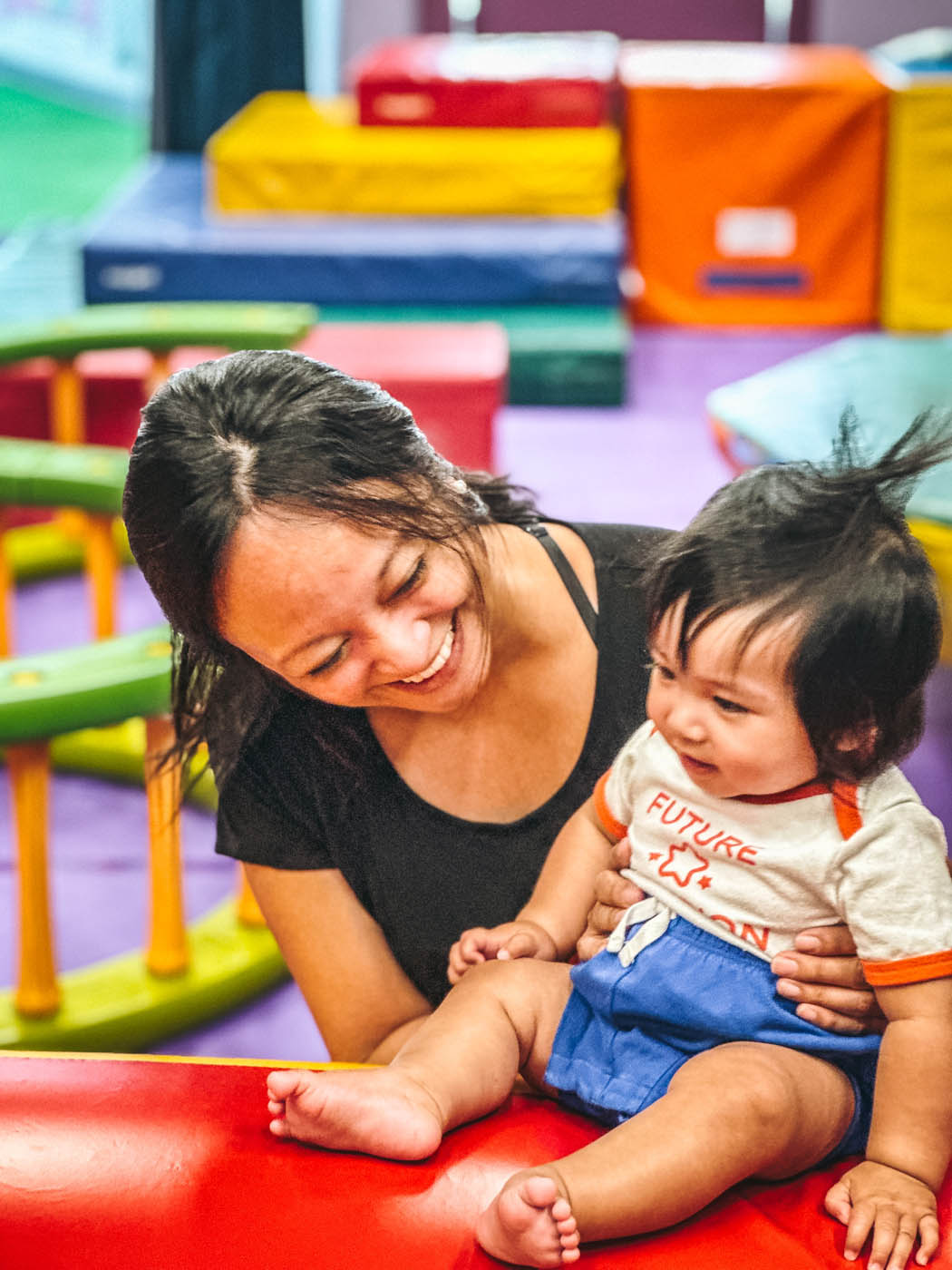 An adult and kid at Romp n' Roll enjoying the benefits of being together at open play.