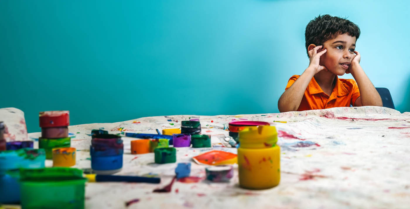 A young boy enjoying the art class at Romp n' Roll