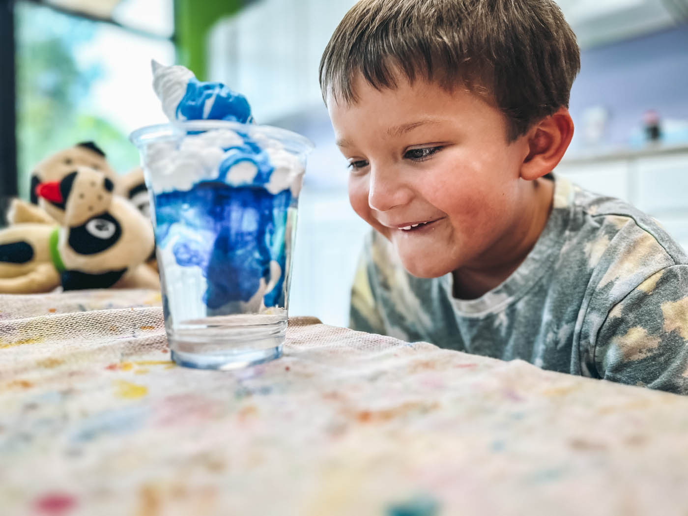 A boy enjoying Romp n' Roll's science focused class, contact us today for more kids activities.