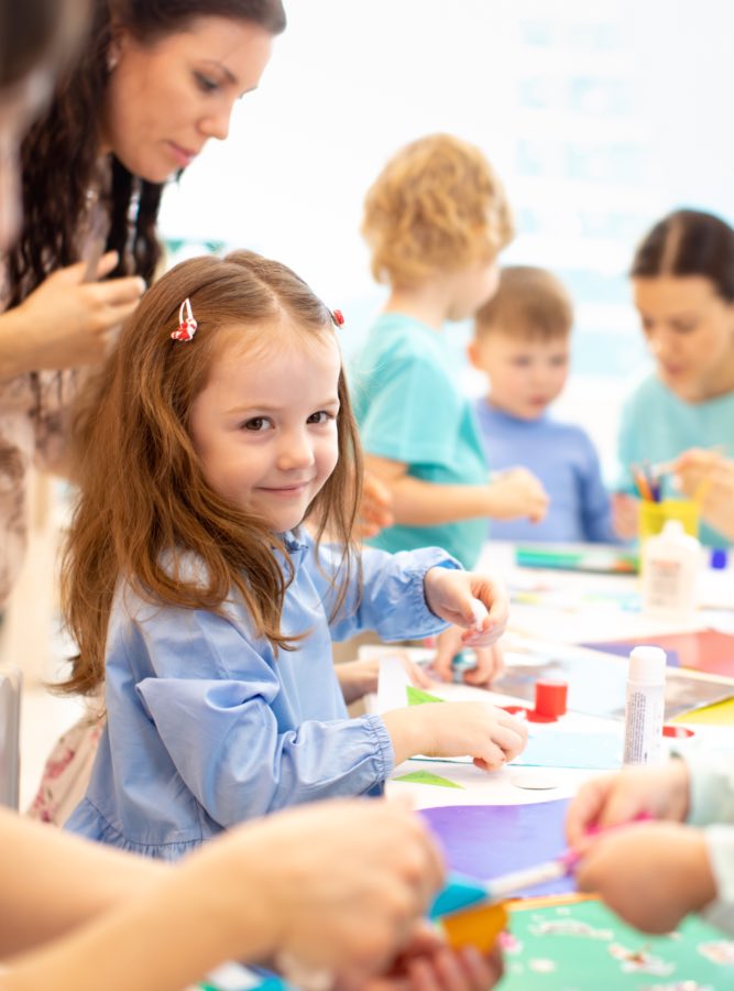 Little girl enjoys sensory play with her mother and classmates at Romp n' Roll in {fran_territory_name, NC.